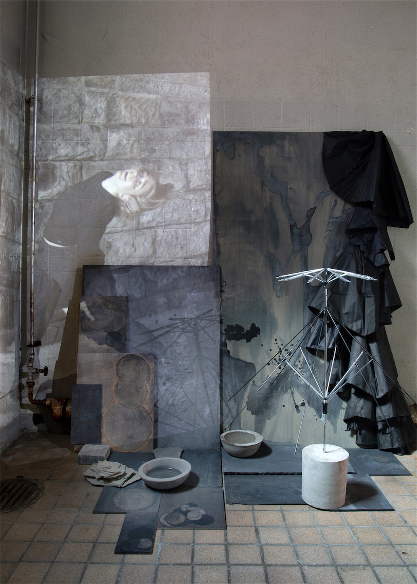 Sculptural collaged installation view detail single channel 4K video projection, paint, linen, wood, stainless steel, nylon, concrete, water, stone slate